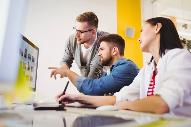 Three people work together in an office - using IP for collaboration to safeguard their ideas.